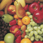 A variety of fresh fruits, grown from carefully tended crops, including apples, pears, grapes, strawberries, bananas, kiwifruit, peaches, tangerines, and raspberries, arranged closely together.